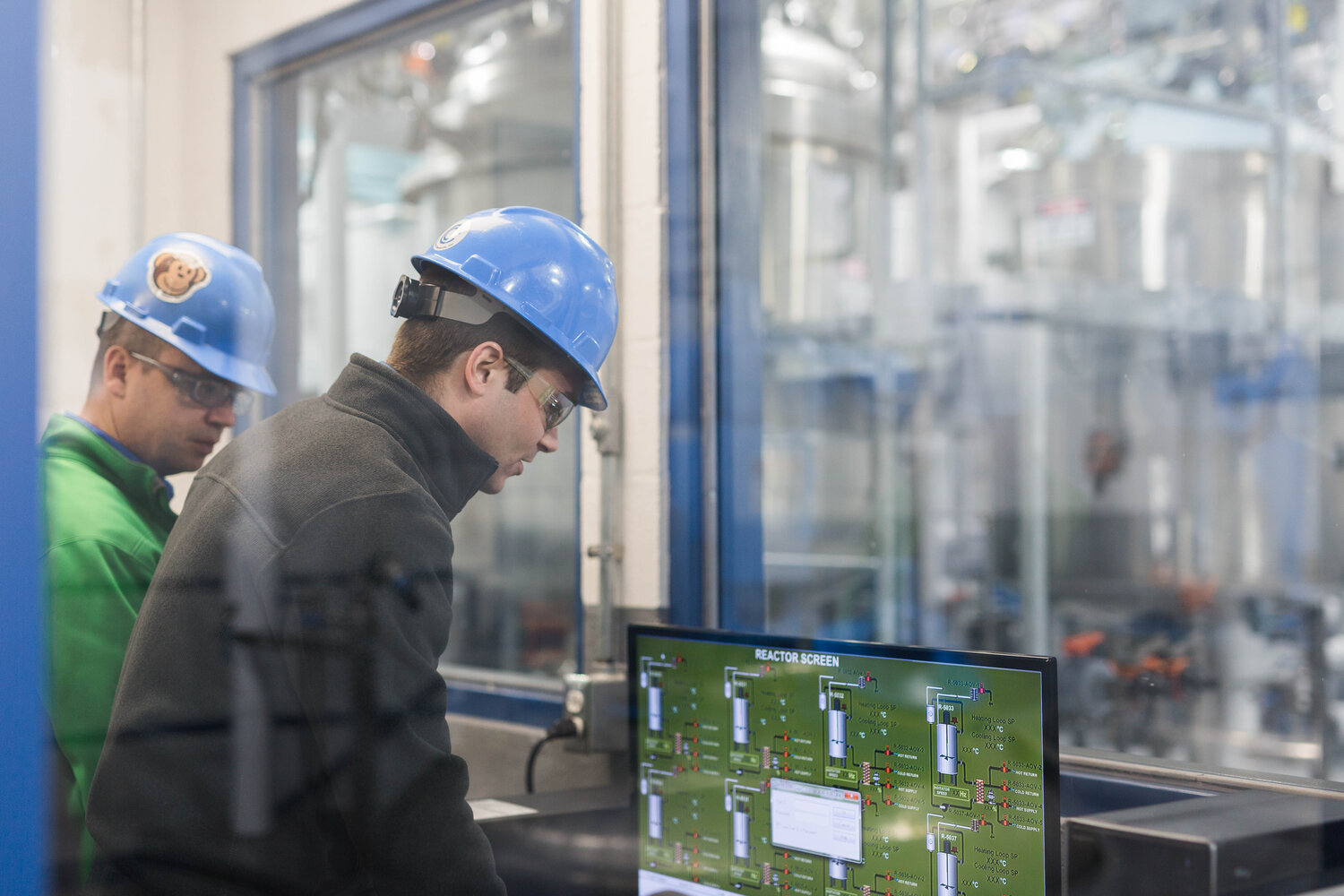 hard hat people looking at reactor settings